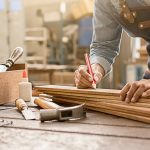 A carpenter is working to remodel the home