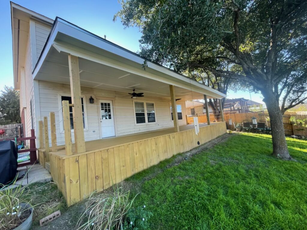 Covered patio cover with ceiling fan and new wood deck railing, Austin metro