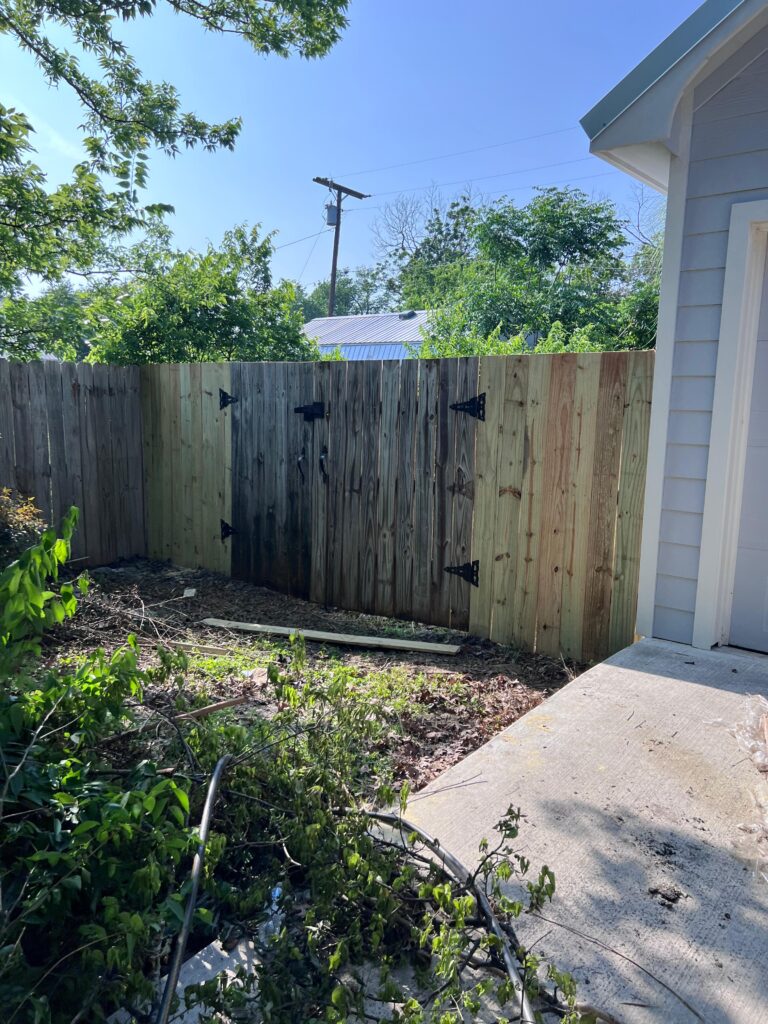Wood privacy fence with double gate built in the Austin metro