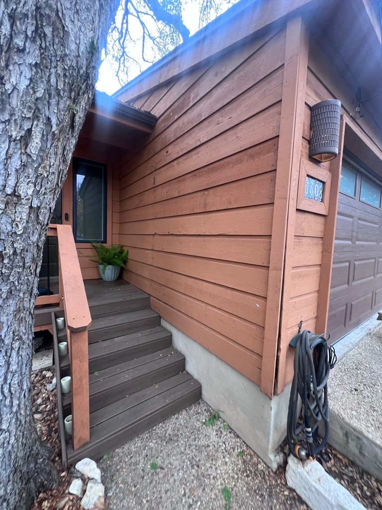 Cedar siding installed on a garage wall in the Austin metro