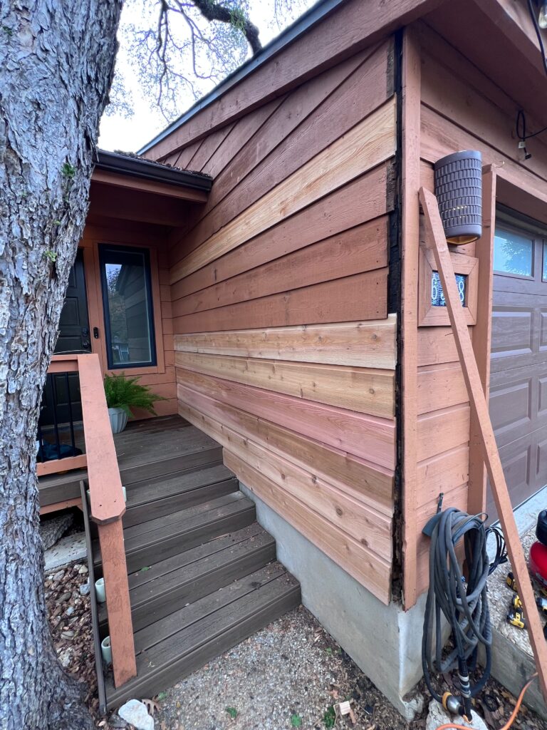 Cedar siding installation in progress on an exterior wall