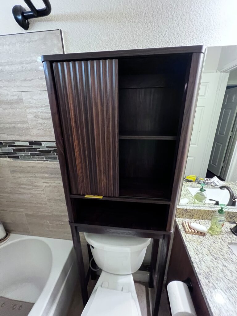 Custom bathroom cabinet built and installed above the toilet